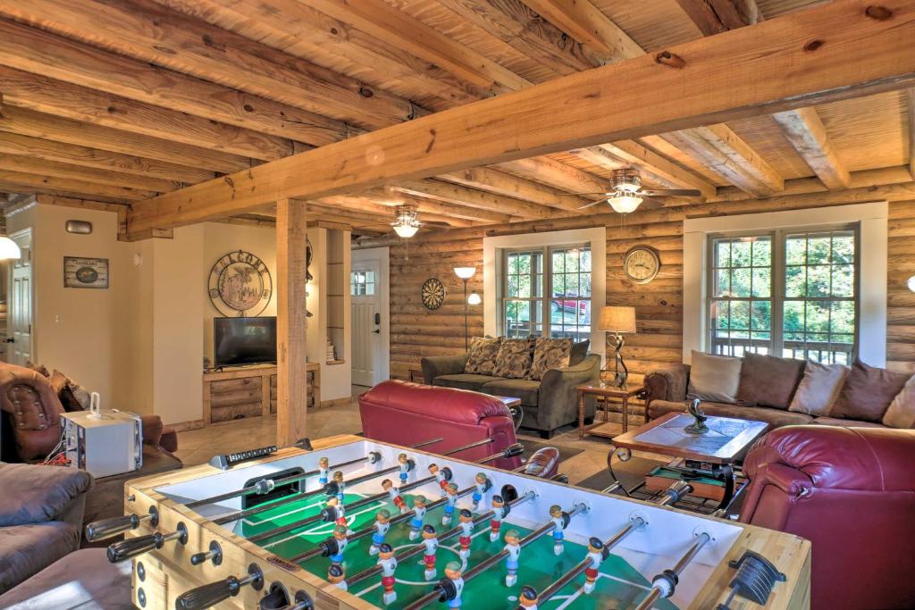 a living room with a large foosball table at Scottsboro Cabin with Fire Pit and Stocked Pond Access in Scottsboro