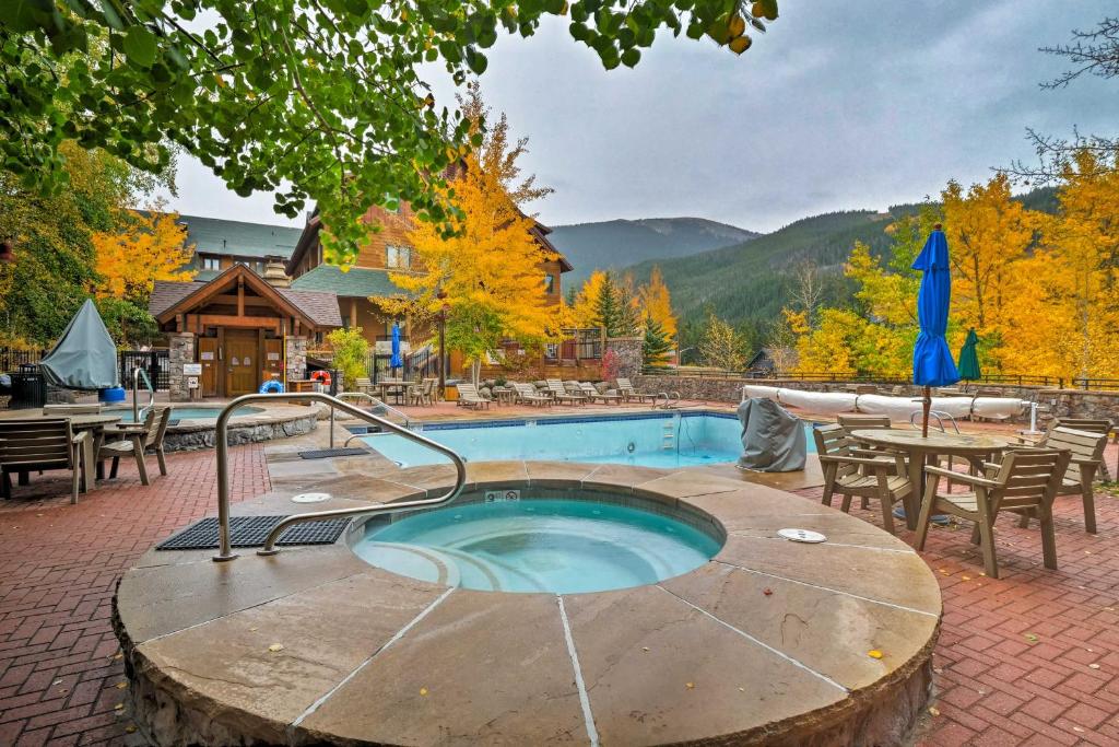 a hot tub in the middle of a patio with a table and chairs at Keystone Ski Condo with Mtn View - Walk to Gondola! in Keystone