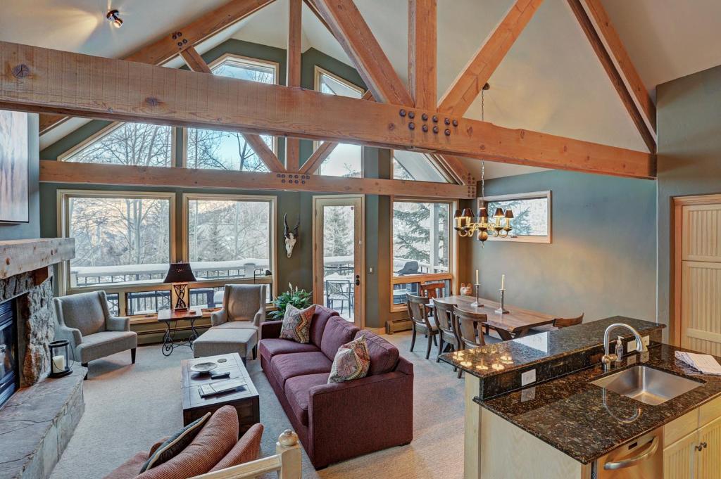 a kitchen and living room with a vaulted ceiling at Pines TH01 in Beaver Creek