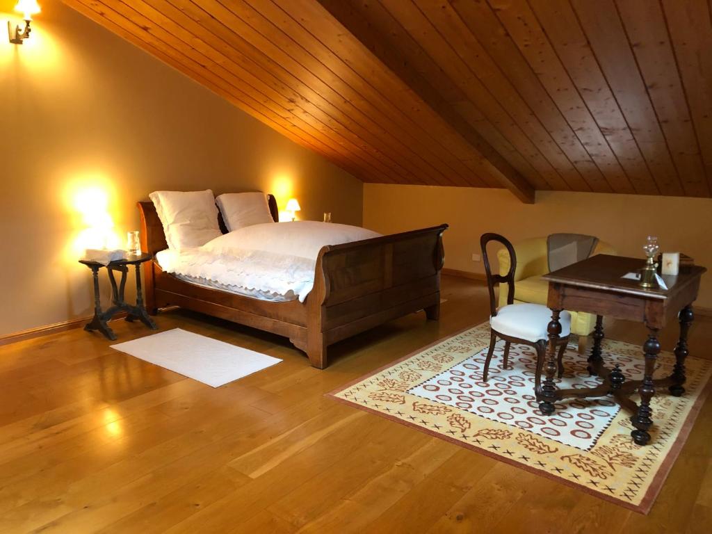een slaapkamer met een bed, een tafel en een bureau bij Vaste chambre proche Toulouse dans Toulousaine 18ème in Bouloc
