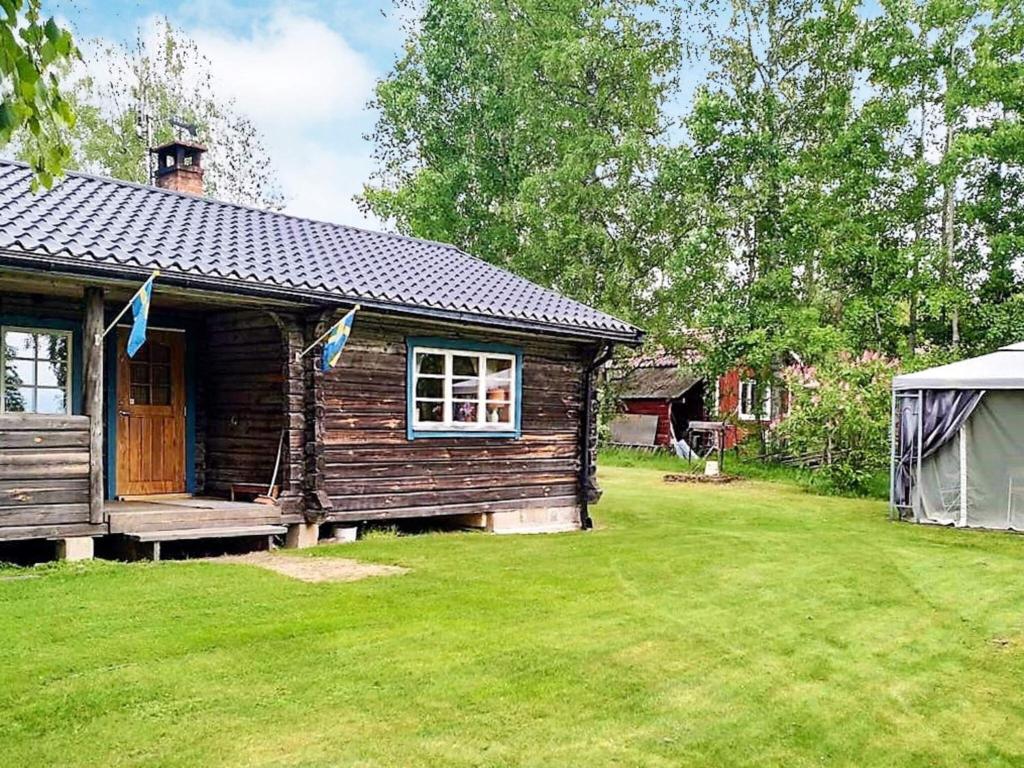a log cabin with a porch and a yard at 6 person holiday home in GRANG RDE in Grangärde
