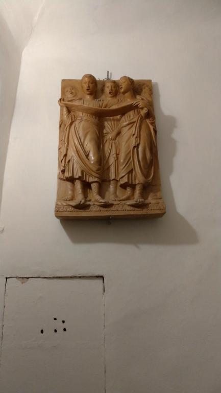 a statue on a wall in a museum at Alighieri Loft in Florence