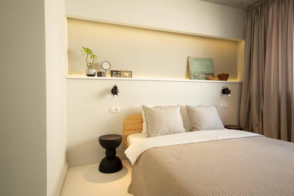 a bedroom with a bed and a shelf on the wall at Zen Apartment - Calea Victoriei in Bucharest