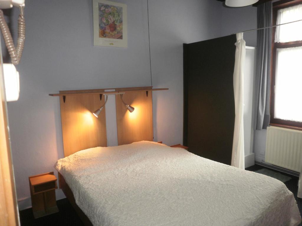 A bed or beds in a room at Le Liège