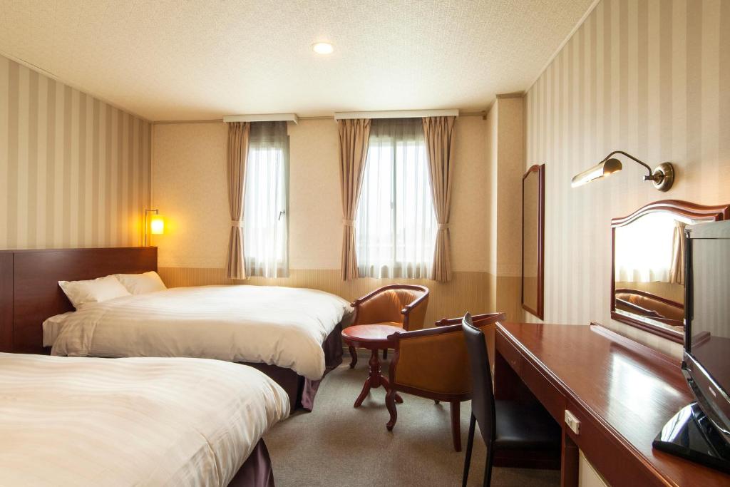 Postel nebo postele na pokoji v ubytování TsukubaNoYu Urban Hotel