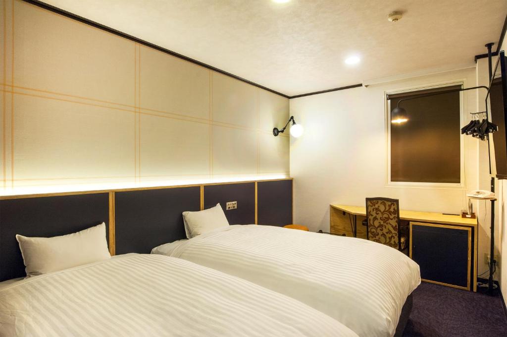 Postel nebo postele na pokoji v ubytování TsukubaNoYu Urban Hotel