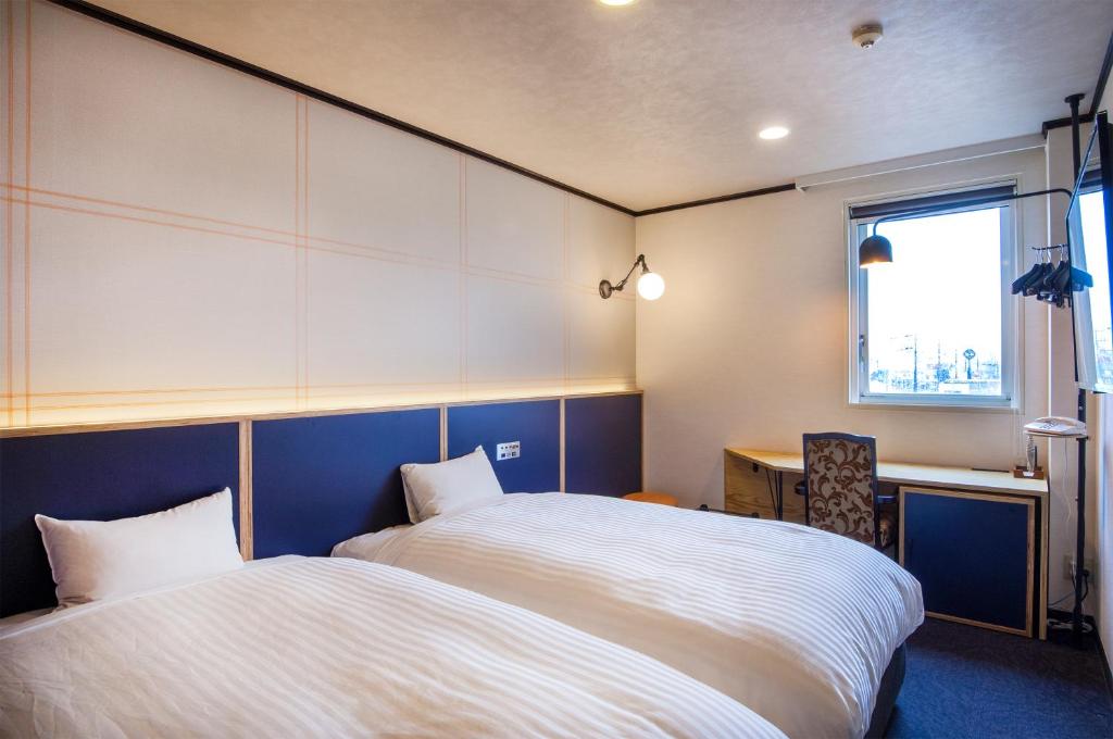 Postel nebo postele na pokoji v ubytování TsukubaNoYu Urban Hotel