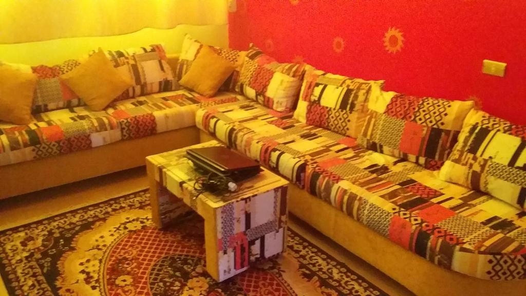 a living room with two couches and a table at Roma House in Aswan