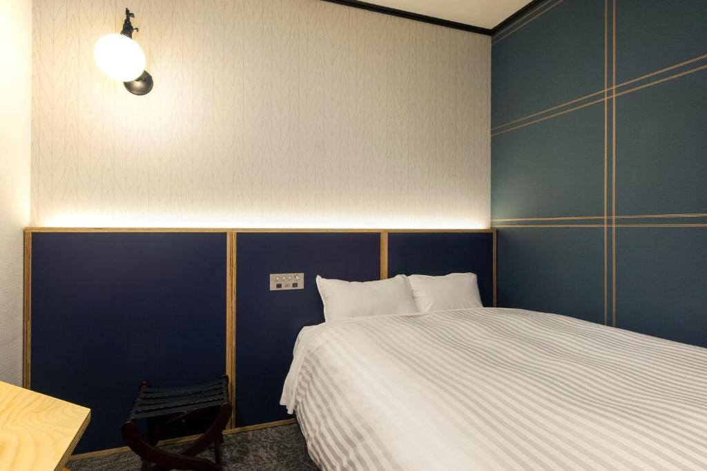 Postel nebo postele na pokoji v ubytování TsukubaNoYu Urban Hotel