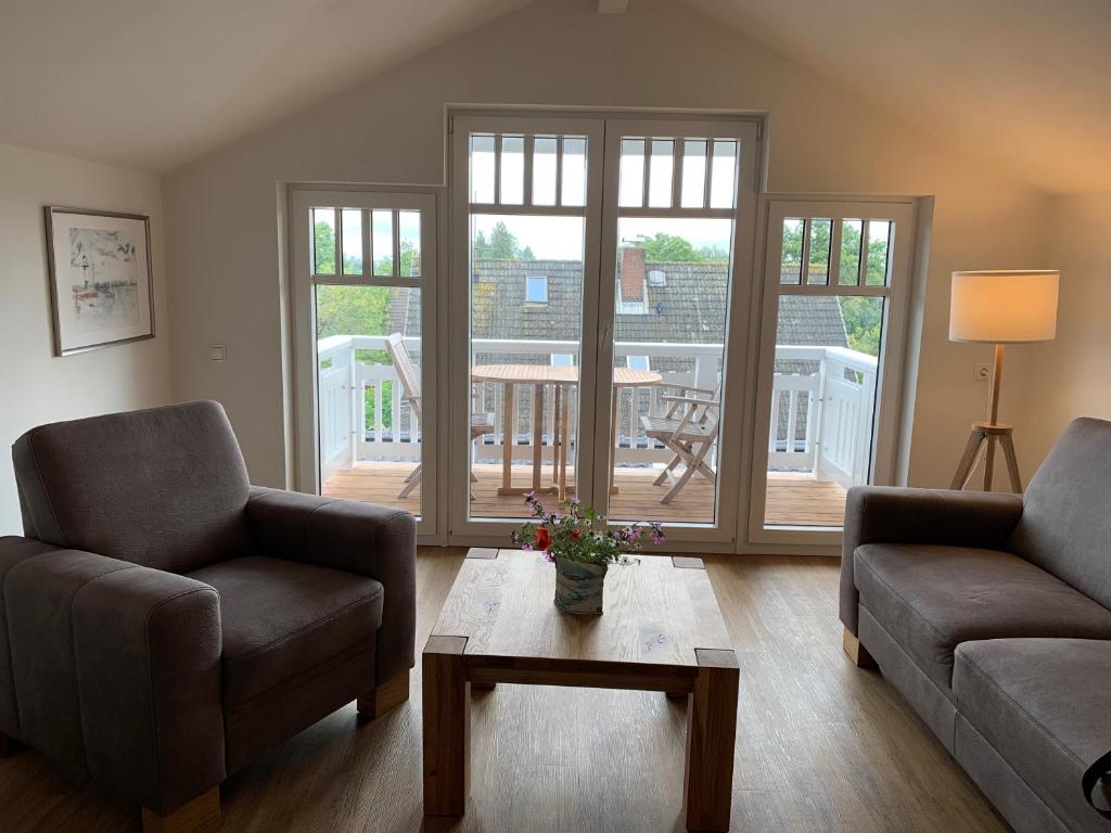 a living room with two chairs and a coffee table at FeWo Herrmann in Petersdorf auf Fehmarn