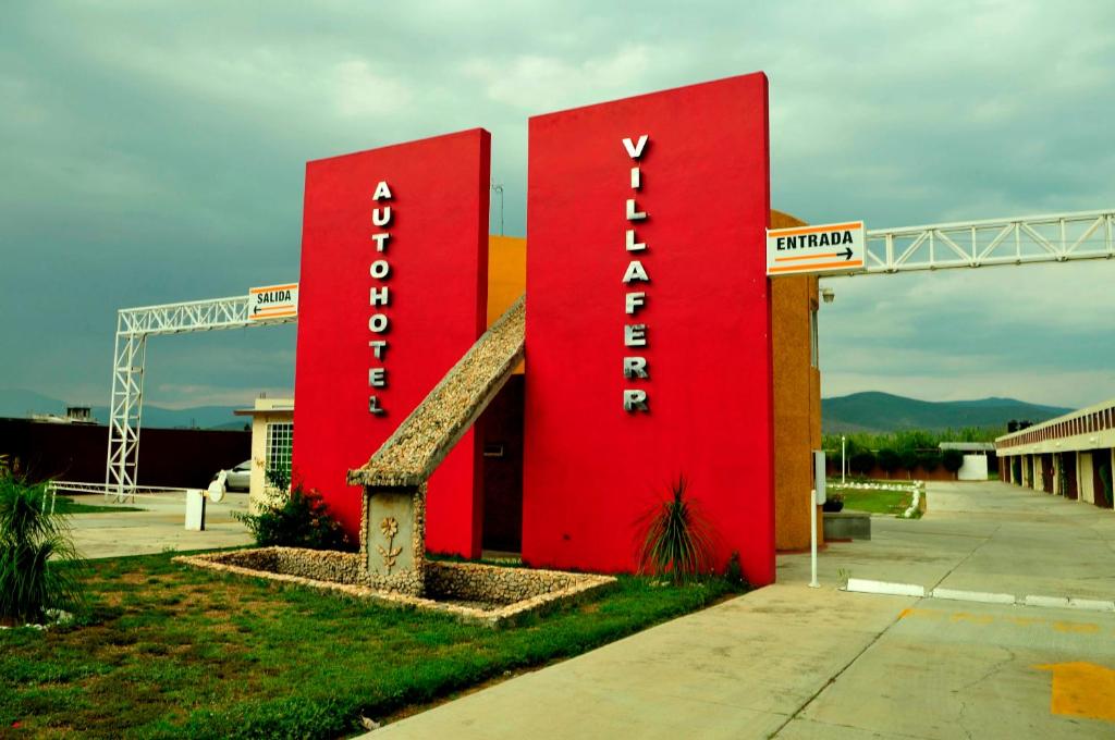 a large red sign for a hotel at Auto Hotel Villaferr in Oaxaca City
