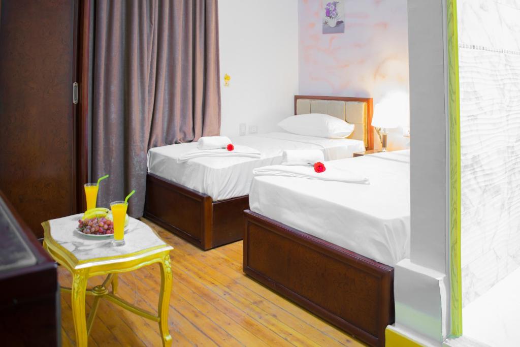 Postel nebo postele na pokoji v ubytování Golden Palace Hotel