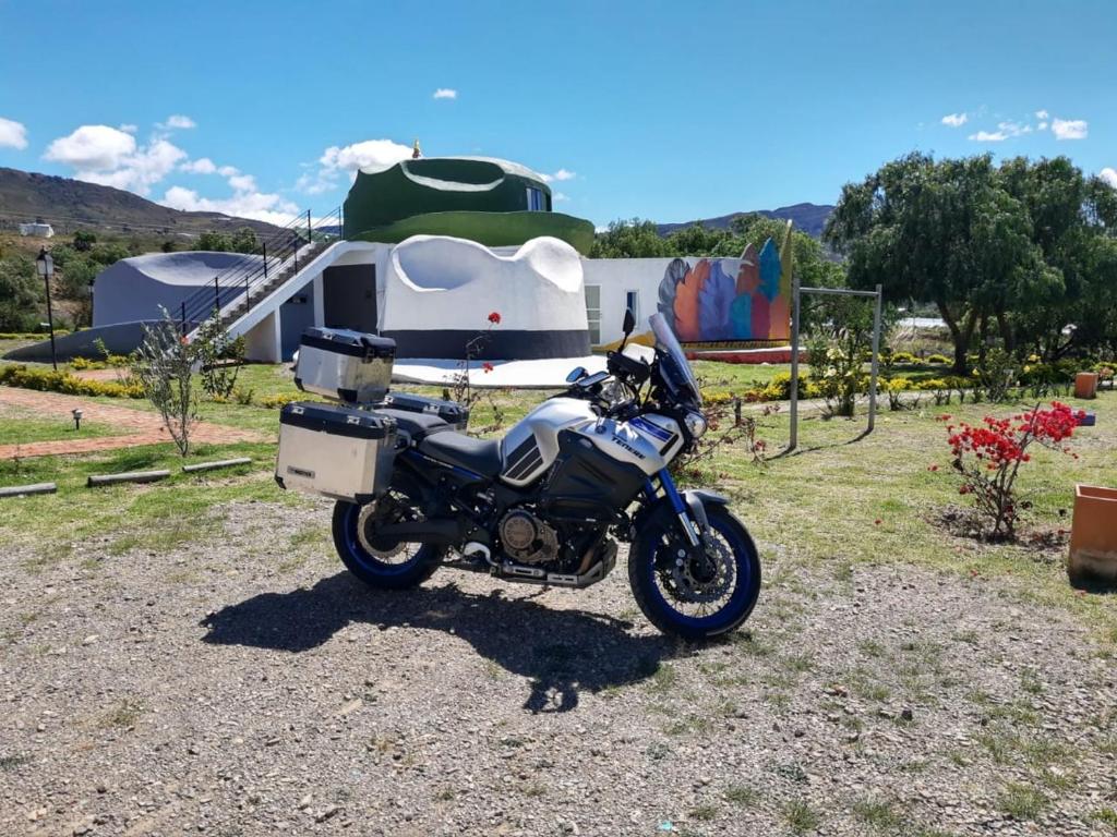 a motorcycle parked in front of a trailer at Entre Sombreros in Villa de Leyva