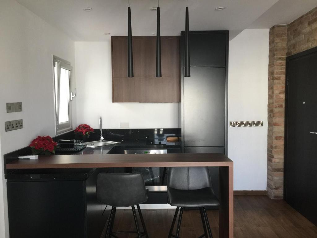 a kitchen with a wooden counter top in a room at Pearl City View Apartment in Paphos