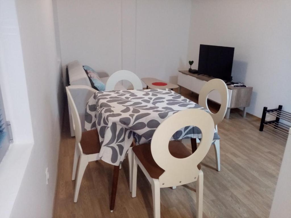 a small room with a table and chairs and a laptop at FLAMANITA APARTMENTS in Skopje