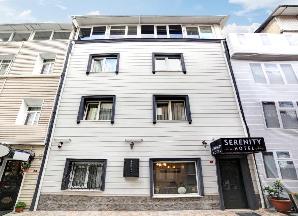 a white building with a sign in front of it at Serenity Boutique Hotel Istanbul in Istanbul