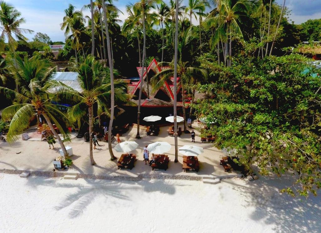 an aerial view of a beach with tables and umbrellas at Pyramid Resort in Panglao Island