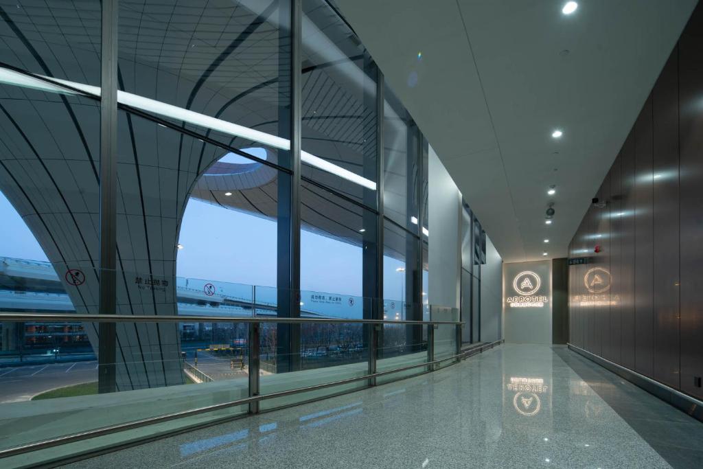 an airport terminal with a view of the airport at Aerotel Beijing Daxing International Airport in Beijing