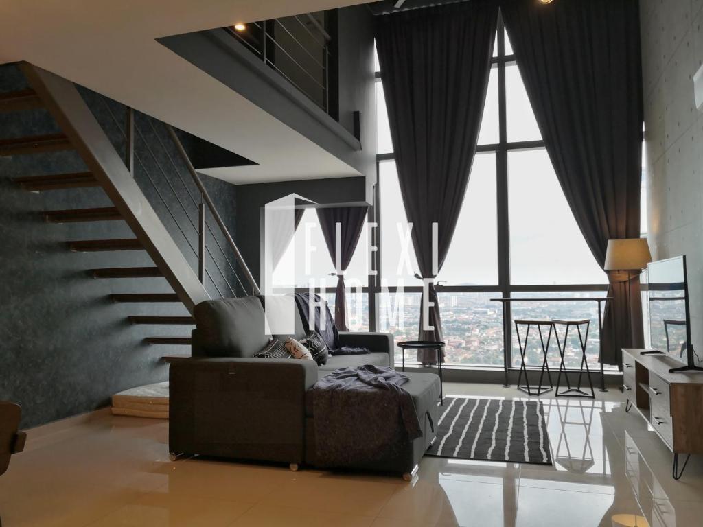 a living room with a couch and large windows at NETFLIX-Pinnacle PJ, Fantastic City View, 1-6 Guests Designed Duplex Home by Flexihome-MY in Petaling Jaya
