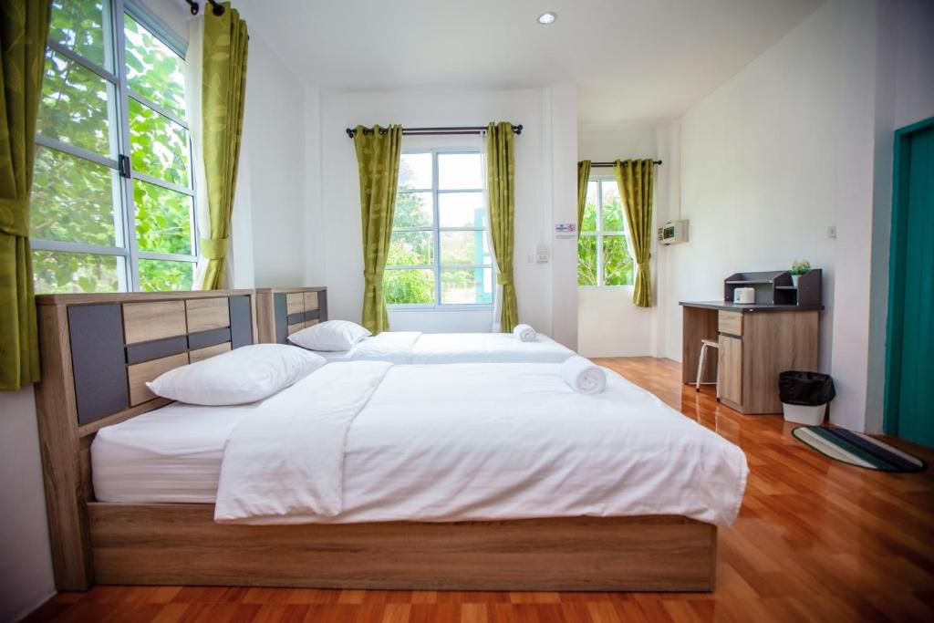 a bedroom with a large bed with white sheets at Hip Home at Hod in Hot