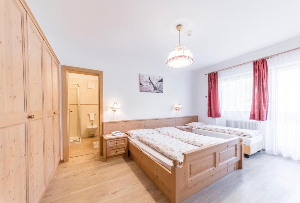 Postel nebo postele na pokoji v ubytování Garni Hotel Residence Diamant
