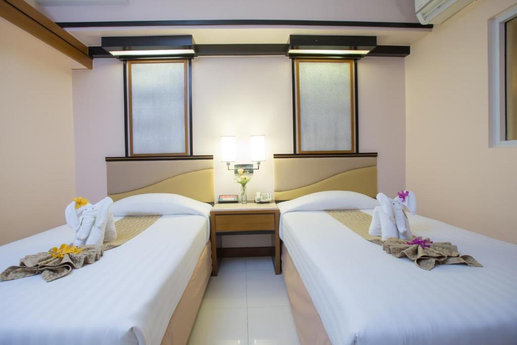 Postel nebo postele na pokoji v ubytování Asia Cha-am Hotel