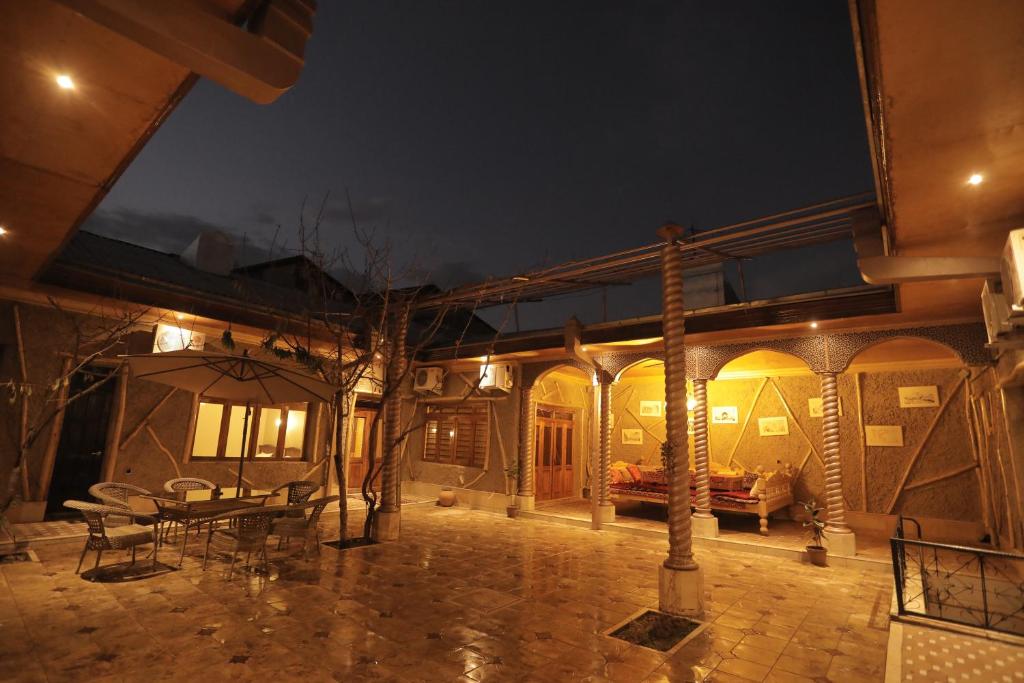 a house with a patio with a table and chairs at "S e a s o n S" in Samarkand