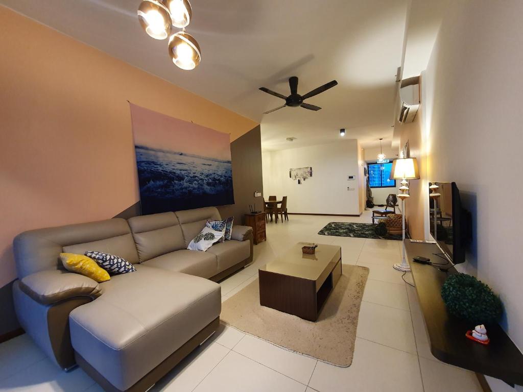 a living room with a couch and a ceiling fan at Landmark by Katana 3BR Romantic Luxury Seaview Homestay Gurney无敌海景三房套房 in Tanjong Tokong
