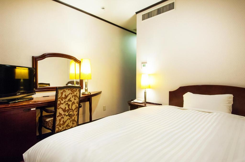 Postel nebo postele na pokoji v ubytování TsukubaNoYu Urban Hotel