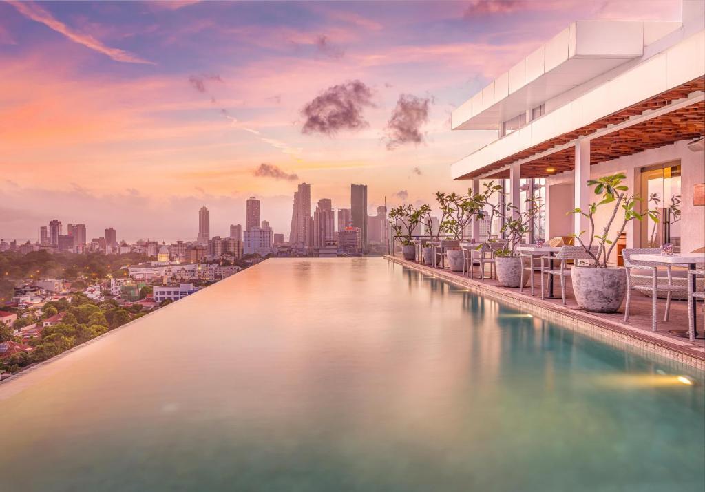 uma piscina com um horizonte urbano ao fundo em Jetwing Colombo Seven em Colombo