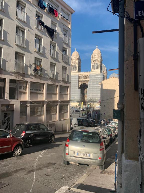 a street with cars parked in front of a building at SOO and CO SooHome in Marseille