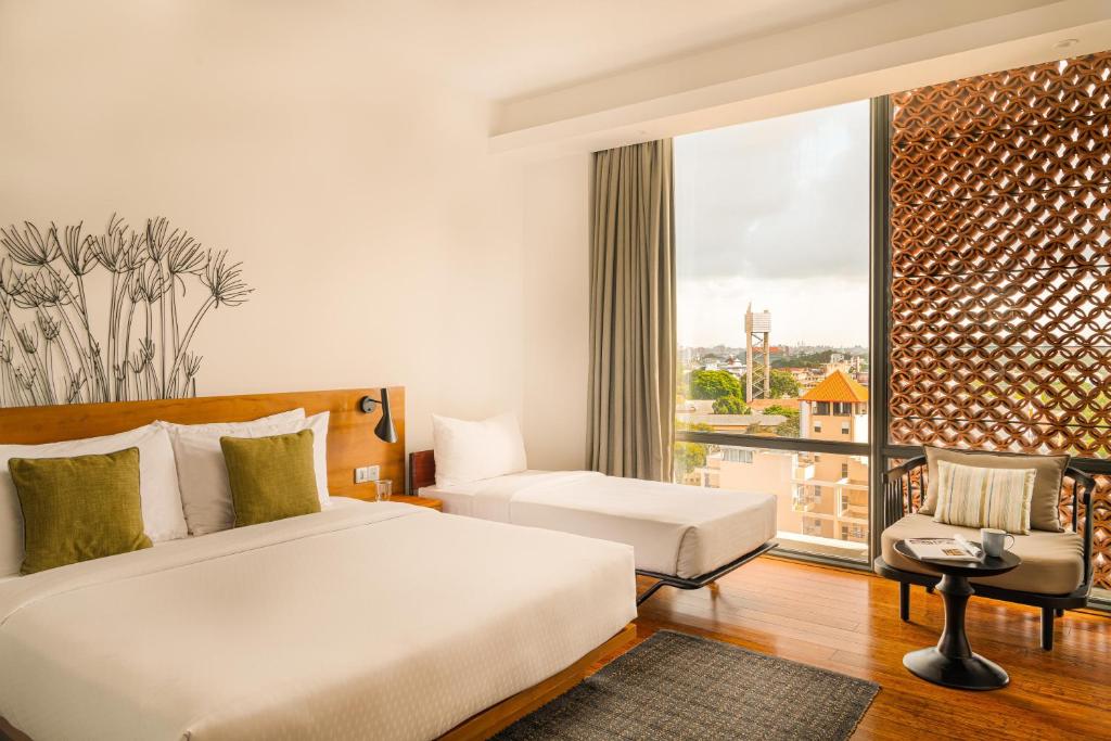 Postel nebo postele na pokoji v ubytování Jetwing Colombo Seven