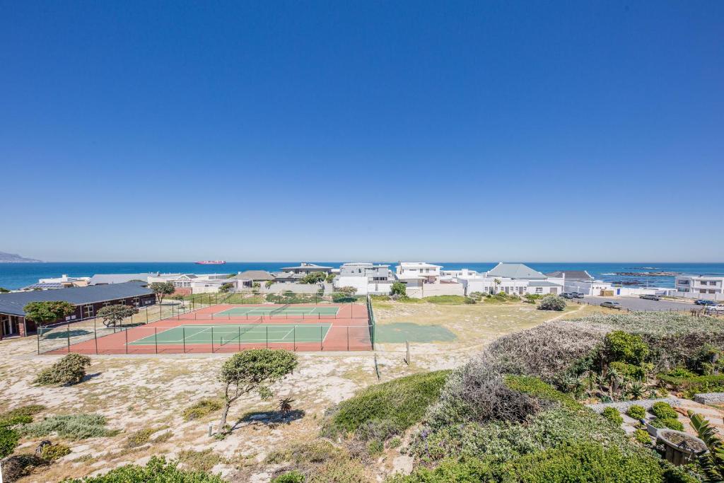 an aerial view of a tennis court on the beach at Big Blue Accommodation in Bloubergstrand