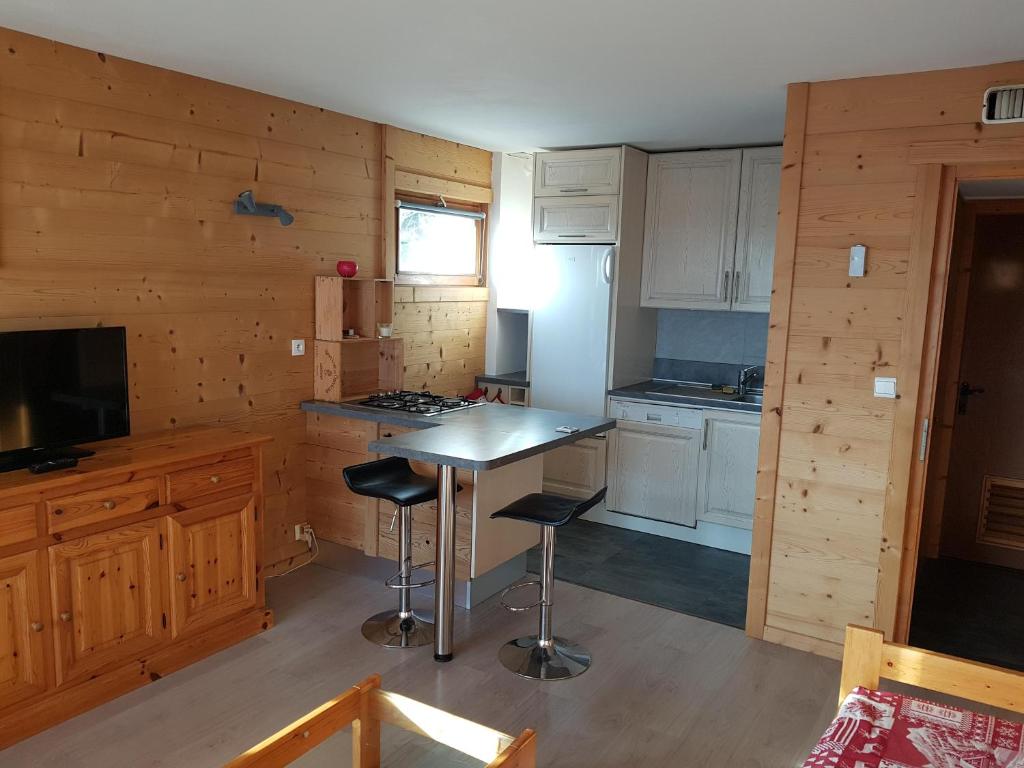 een keuken met een tafel en stoelen in een hut bij La Vardase in Le Grand-Bornand
