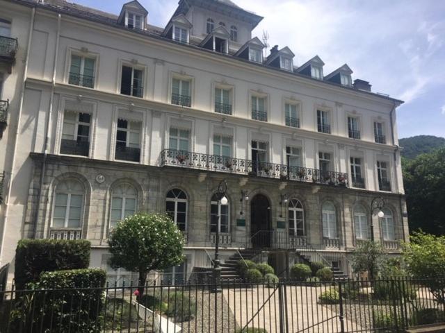 a large white building with a fence in front of it at Palais d'étigny in Luchon