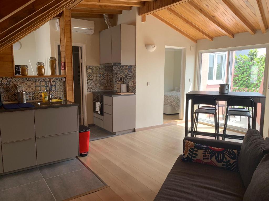 a kitchen and living room with a table and chairs at Apartment2 with terrace and a view near Amoreiras in Lisbon