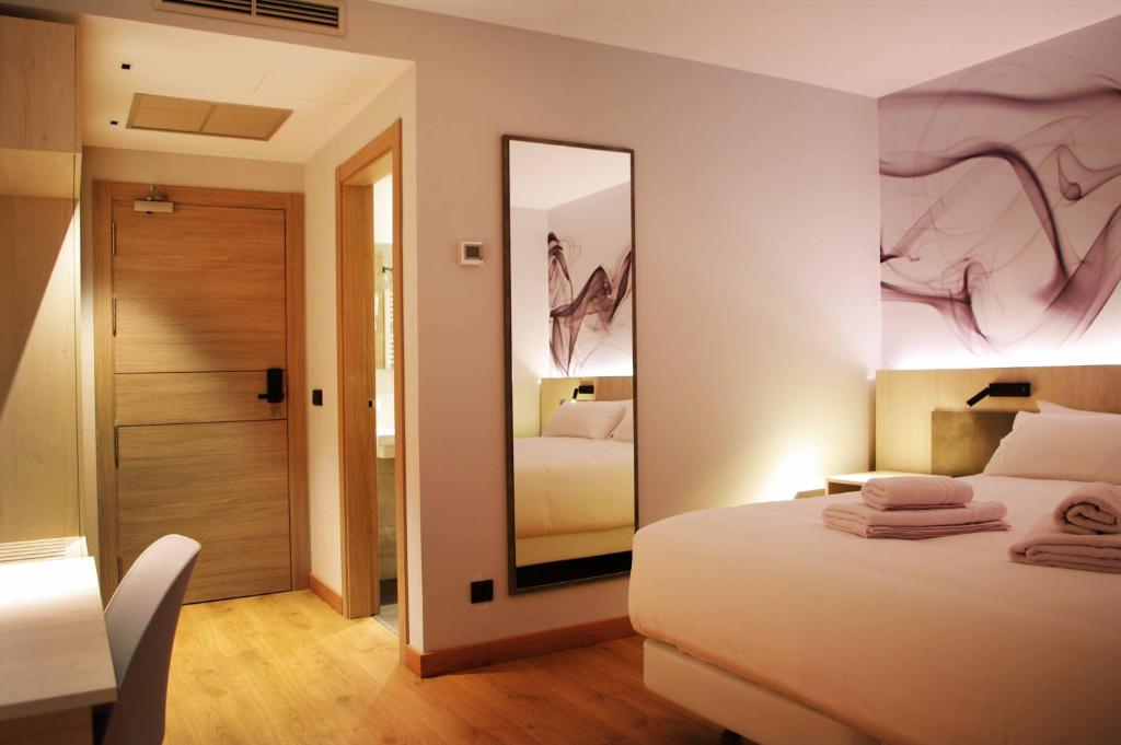 Postel nebo postele na pokoji v ubytování Hotel NERU con Encanto