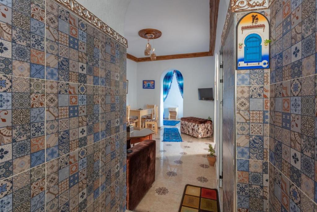 un couloir avec des murs carrelés et un salon dans l'établissement Dar Sidi Mfedal, à Chefchaouen