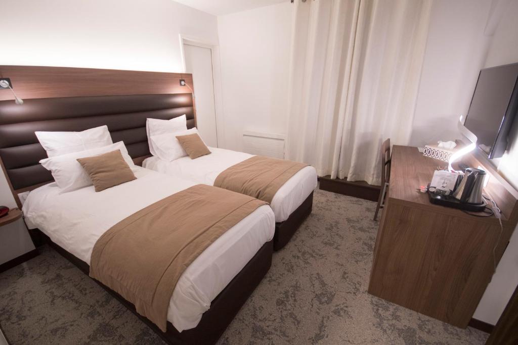 Posteľ alebo postele v izbe v ubytovaní Hôtel Bastide