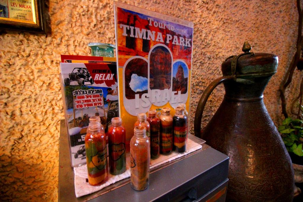 a display of soda bottles on a counter with a poster at Sunset Inn in Eilat