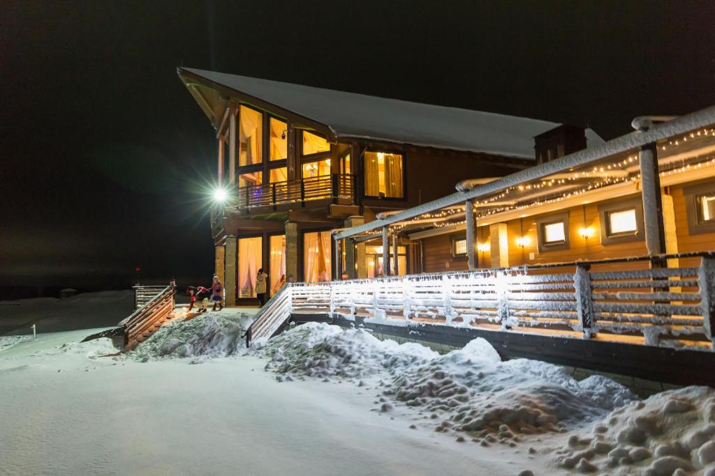 a building with lights in the snow at night at Gorki Golf Resort in Gorki