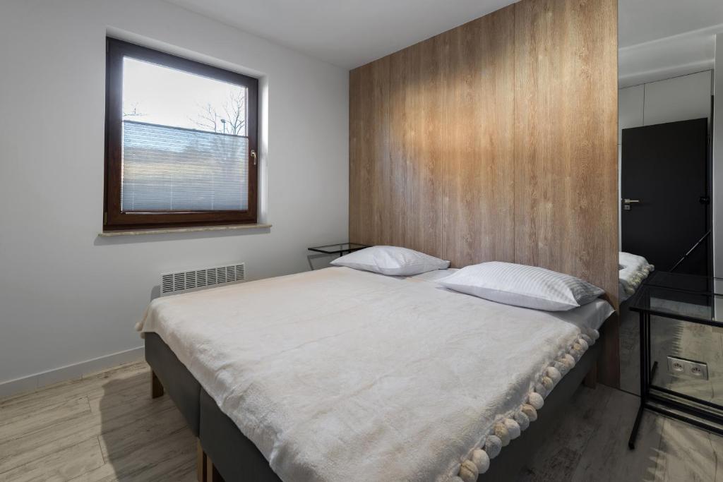 Posteľ alebo postele v izbe v ubytovaní Apartament Widok