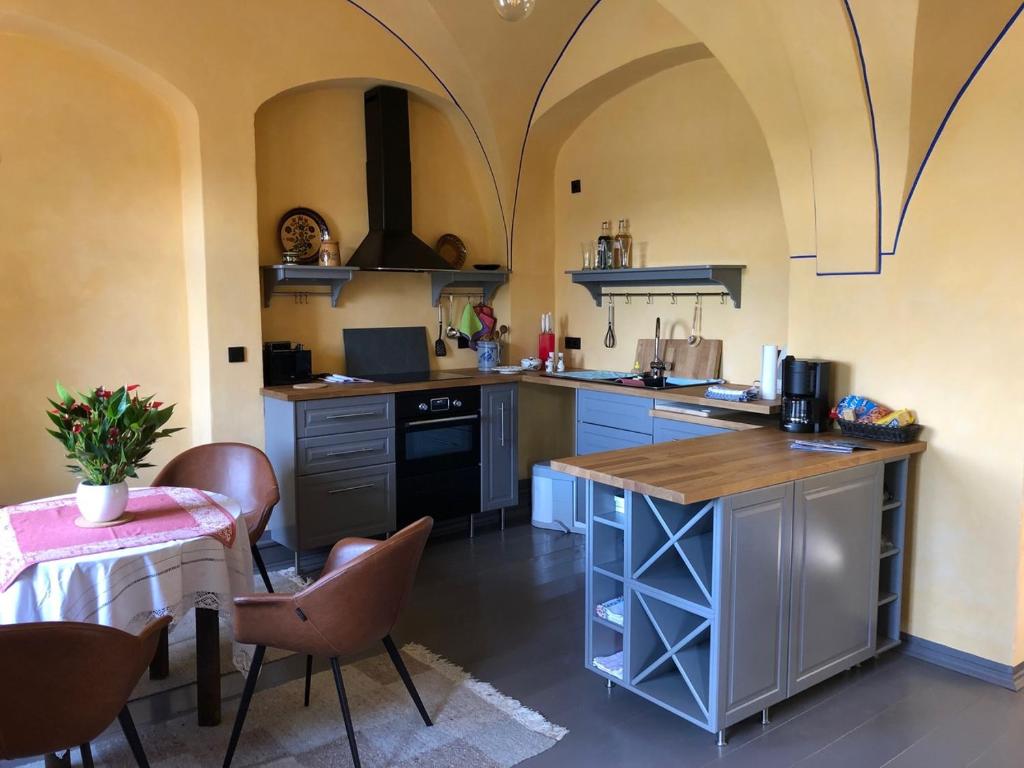 a kitchen with a counter and a table with chairs at Wolke 33 in Annaberg-Buchholz