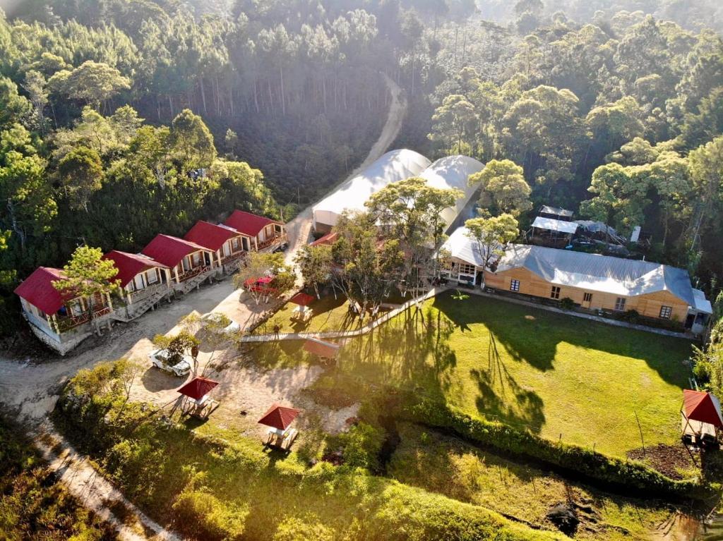 an aerial view of a farm with buildings and trees at Cabañas Junkolal Tziscao in Santiago