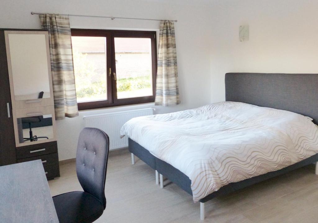 Postel nebo postele na pokoji v ubytování Guest House Magyarlukafa