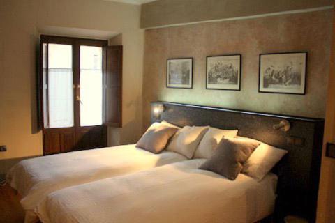 a bedroom with a large white bed with pillows at Casa Rural Usategieta in Genevilla