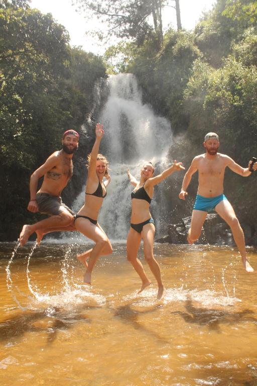 a group of people jumping in the water at Green Hostal Popayan in Popayan