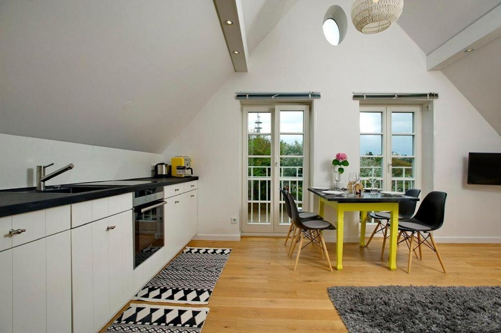 a kitchen with a yellow table and chairs in a room at Yellow-Upmarine in Westerland (Sylt)