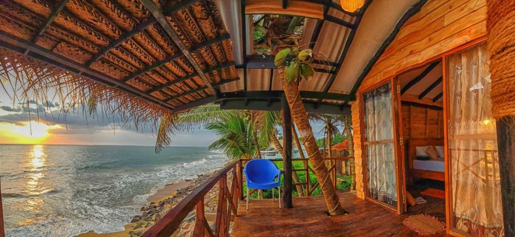 a room with a balcony with a view of the ocean at Indika Beach Villa in Galle