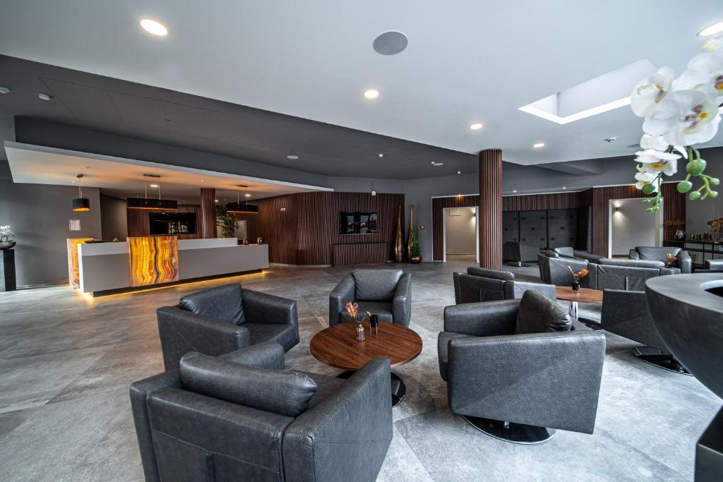 a lobby with couches and a table in a building at EE Hotel in Kassel